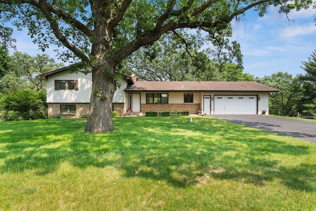 17855 Round Lake Blvd NW, Andover, MN 55304 - split level home featuring driveway, an attached garage, brick siding, a chimney, and a front yard