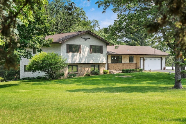 17855 Round Lake Blvd NW, Andover, MN 55304 - tri-level home featuring an attached garage, a front yard, brick siding, and driveway