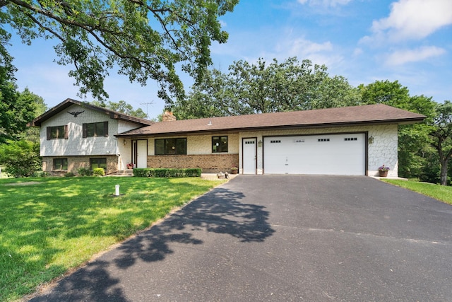 17855 Round Lake Blvd NW, Andover, MN 55304 - tri-level home featuring asphalt driveway, an attached garage, a front yard, a chimney, and brick siding