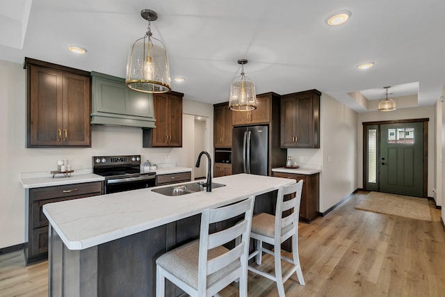 5815 Rivers Edge Dr, Saint Cloud, MN 56303 - kitchen with electric range oven, freestanding refrigerator, a sink, light wood-type flooring, and baseboards