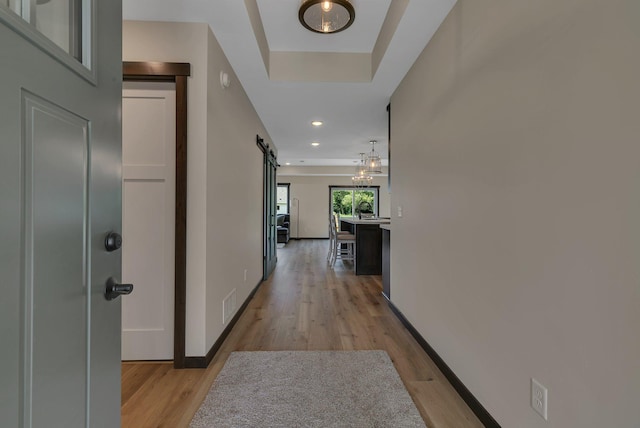 5815 Rivers Edge Dr, Saint Cloud, MN 56303 - hallway with a barn door, light wood-style floors, baseboards, and recessed lighting
