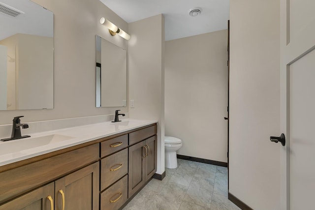 5815 Rivers Edge Dr, Saint Cloud, MN 56303 - bathroom featuring toilet, double vanity, and baseboards