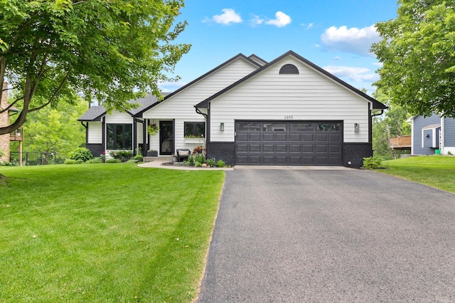 6855 Timber Crest Dr, Maple Grove, MN 55311 - view of front of property featuring an attached garage, asphalt driveway, a front yard, and brick siding