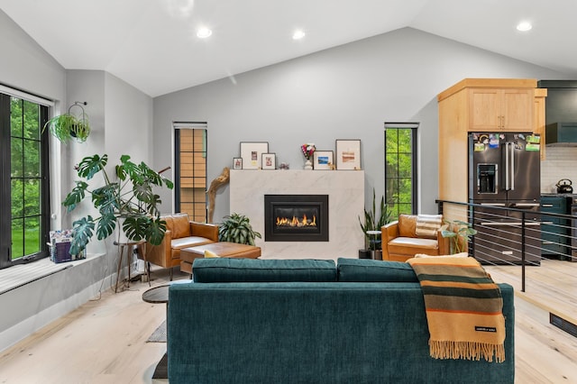 6855 Timber Crest Dr, Maple Grove, MN 55311 - living room featuring lofted ceiling, light wood-style flooring, a premium fireplace, and recessed lighting