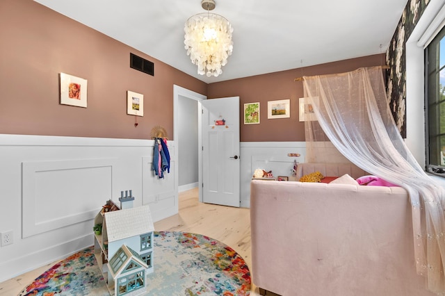 6855 Timber Crest Dr, Maple Grove, MN 55311 - bedroom featuring a chandelier, wainscoting, and wood finished floors