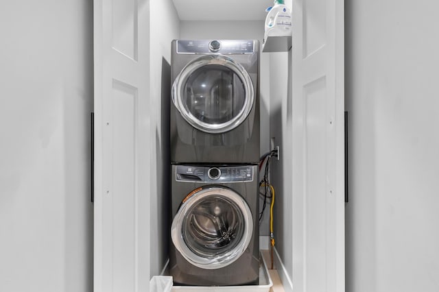 6855 Timber Crest Dr, Maple Grove, MN 55311 - laundry area featuring stacked washing machine and dryer and baseboards