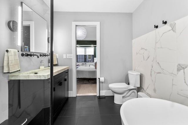 6855 Timber Crest Dr, Maple Grove, MN 55311 - full bath with a freestanding tub, connected bathroom, vanity, and tile patterned flooring