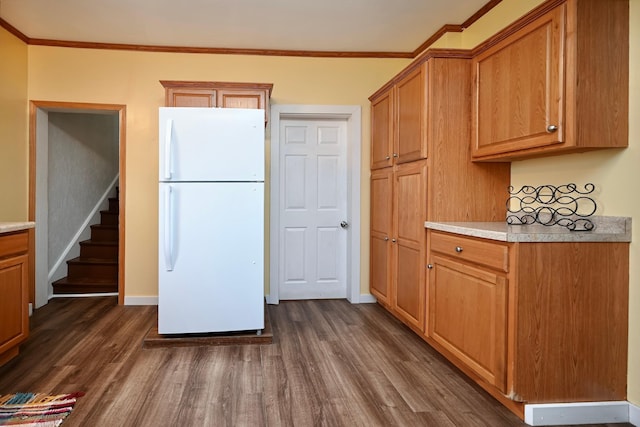 29827 Elfmanns Dr, Wilson Twp, MN 55987 - kitchen with freestanding refrigerator, dark wood-style flooring, light countertops, baseboards, and ornamental molding
