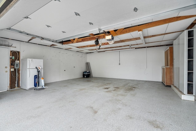 2022 Nokomis Ave, Saint Paul, MN 55119 - garage featuring freestanding refrigerator and a garage door opener