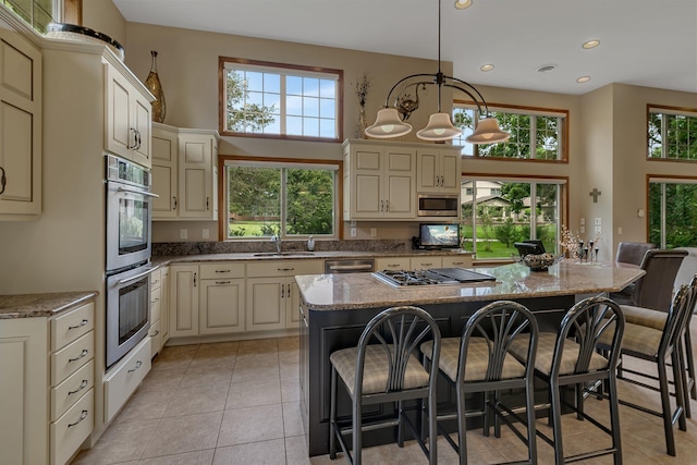 512 Greenview Ct, Sartell, MN 56377 - kitchen with cream cabinetry, stainless steel appliances, healthy amount of natural light, a towering ceiling, and recessed lighting