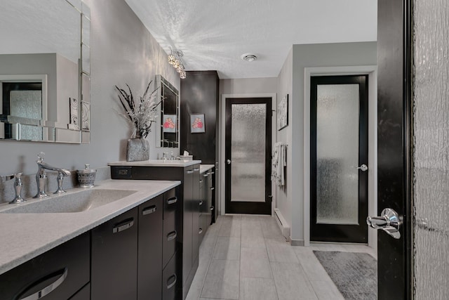 512 Greenview Ct, Sartell, MN 56377 - full bathroom with two vanities, a textured ceiling, and tile patterned floors