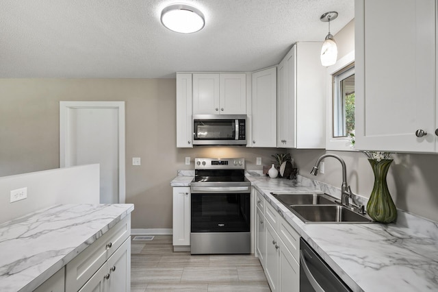 17900 Weaver Lake Dr, Maple Grove, MN 55311 - kitchen with appliances with stainless steel finishes, a sink, a textured ceiling, white cabinets, and baseboards