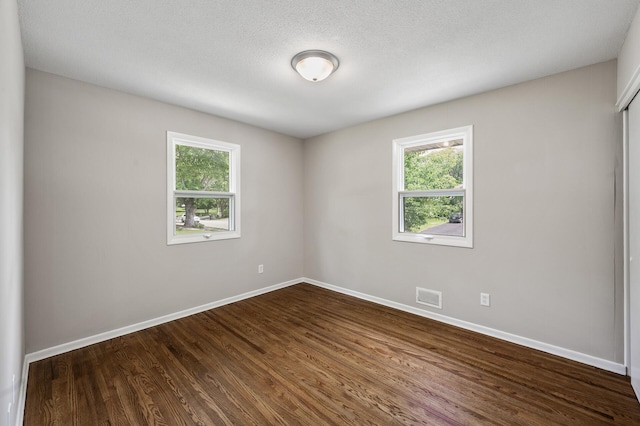 17900 Weaver Lake Dr, Maple Grove, MN 55311 - spare room featuring plenty of natural light, baseboards, and dark wood finished floors
