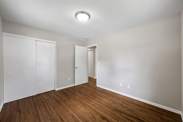 17900 Weaver Lake Dr, Maple Grove, MN 55311 - unfurnished bedroom featuring dark wood-type flooring, baseboards, and a closet