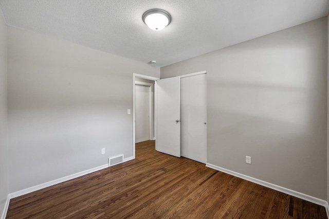 17900 Weaver Lake Dr, Maple Grove, MN 55311 - unfurnished bedroom featuring wood finished floors, a closet, baseboards, and a textured ceiling
