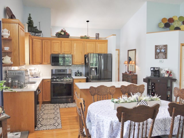 17098 Pheasant Meadow Ln SW, Prior Lake, MN 55372 - kitchen with appliances with stainless steel finishes, light countertops, light wood finished floors, vaulted ceiling, and backsplash