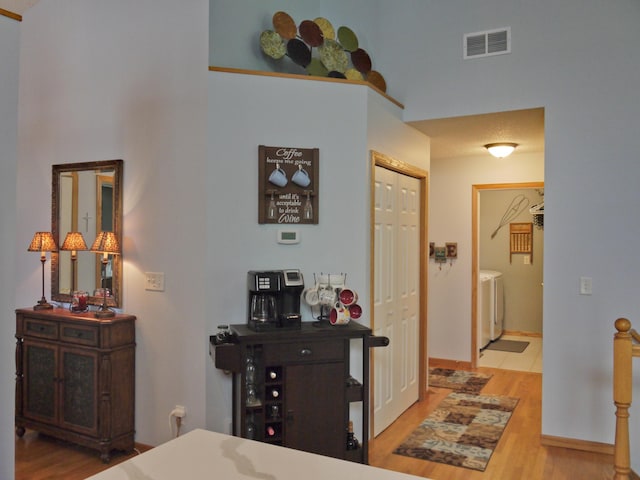 17098 Pheasant Meadow Ln SW, Prior Lake, MN 55372 - hallway with wood finished floors, washer / clothes dryer, and a high ceiling