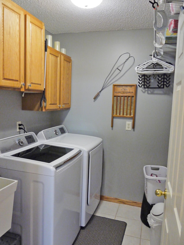 17098 Pheasant Meadow Ln SW, Prior Lake, MN 55372 - laundry room with cabinet space, independent washer and dryer, light tile patterned floors, and a textured ceiling