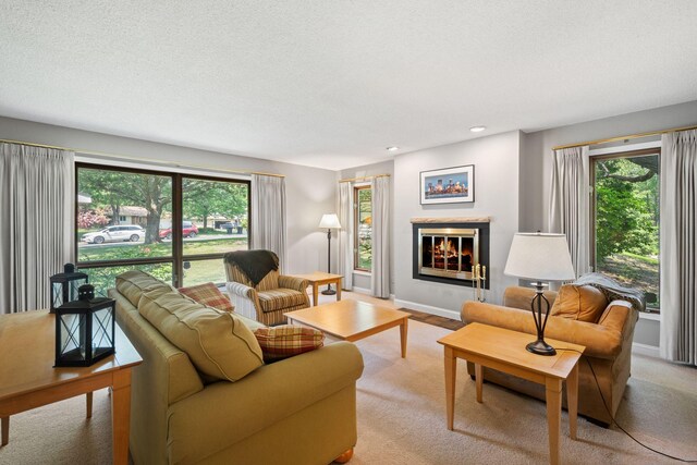 3440 Glenarden Rd, Arden Hills, MN 55112 - living room featuring a glass covered fireplace, recessed lighting, a textured ceiling, and light carpet