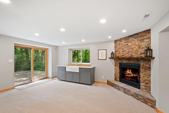 3440 Glenarden Rd, Arden Hills, MN 55112 - unfurnished living room featuring light carpet, recessed lighting, and a fireplace