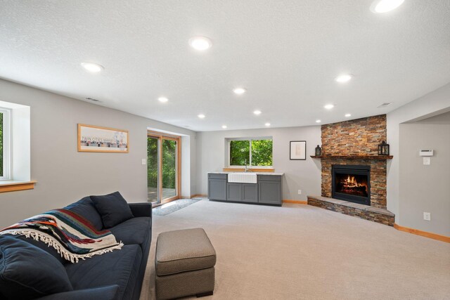 3440 Glenarden Rd, Arden Hills, MN 55112 - living area featuring recessed lighting, light carpet, and a stone fireplace