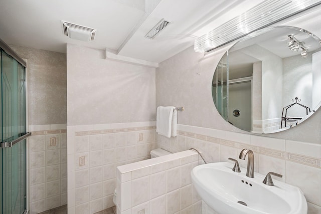 3440 Glenarden Rd, Arden Hills, MN 55112 - bathroom featuring tile walls, a stall shower, and a wainscoted wall