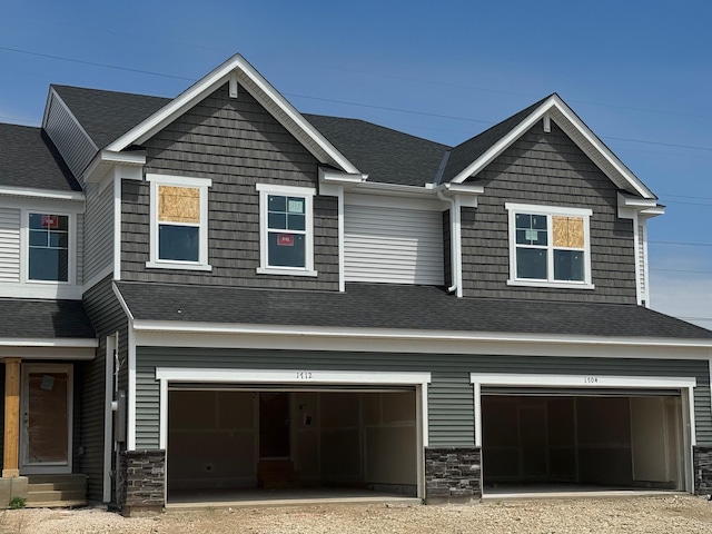 1712 Tyrone Dr, Shakopee, MN 55379 - craftsman-style house with a garage, stone siding, dirt driveway, and roof with shingles