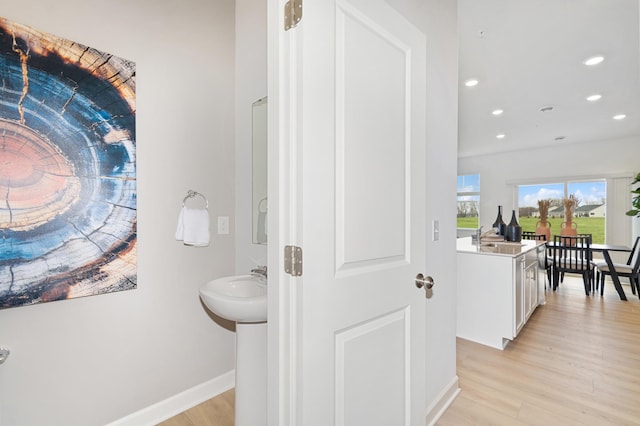 2134 Tyrone Dr, Shakopee, MN 55379 - bathroom with a sink, wood finished floors, baseboards, and recessed lighting