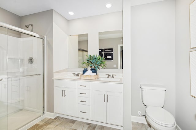 2134 Tyrone Dr, Shakopee, MN 55379 - full bath with a stall shower, toilet, double vanity, baseboards, and wood finished floors