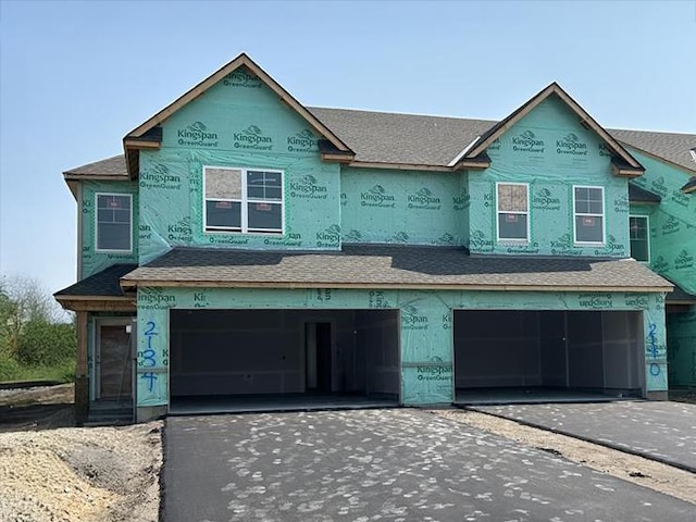 2134 Tyrone Dr, Shakopee, MN 55379 - unfinished property featuring an attached garage, driveway, and a shingled roof