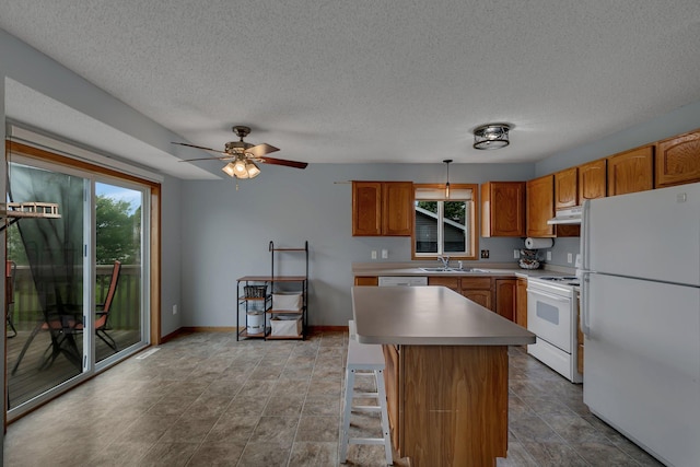 1285 Stone Ridge Rd, Sauk Rapids, MN 56379 - kitchen featuring white appliances, a sink, under cabinet range hood, plenty of natural light, and a textured ceiling