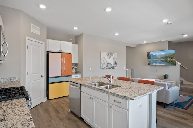 13936 146th Ave N, Dayton, MN 55327 - kitchen with appliances with stainless steel finishes, open floor plan, dark wood-style flooring, white cabinets, and light stone countertops
