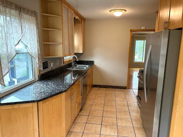 3500 Abbott Ave N, Robbinsdale, MN 55422 - kitchen with appliances with stainless steel finishes, open shelves, light tile patterned flooring, and dark stone countertops