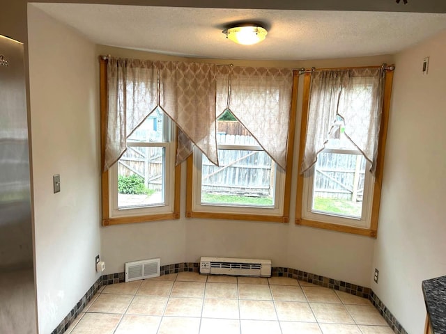 3500 Abbott Ave N, Robbinsdale, MN 55422 - unfurnished dining area with a baseboard radiator and tile patterned flooring