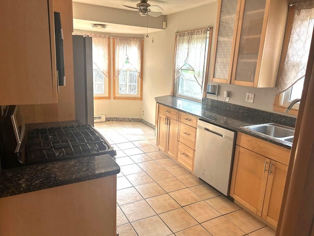 3500 Abbott Ave N, Robbinsdale, MN 55422 - kitchen featuring stainless steel dishwasher, plenty of natural light, light tile patterned floors, and range with gas cooktop