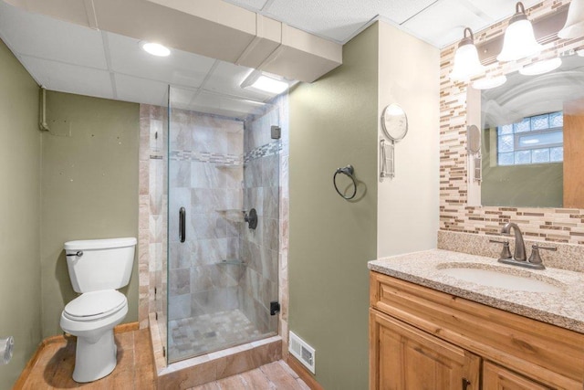 3500 Abbott Ave N, Robbinsdale, MN 55422 - bathroom with vanity, a shower stall, decorative backsplash, and wood finished floors