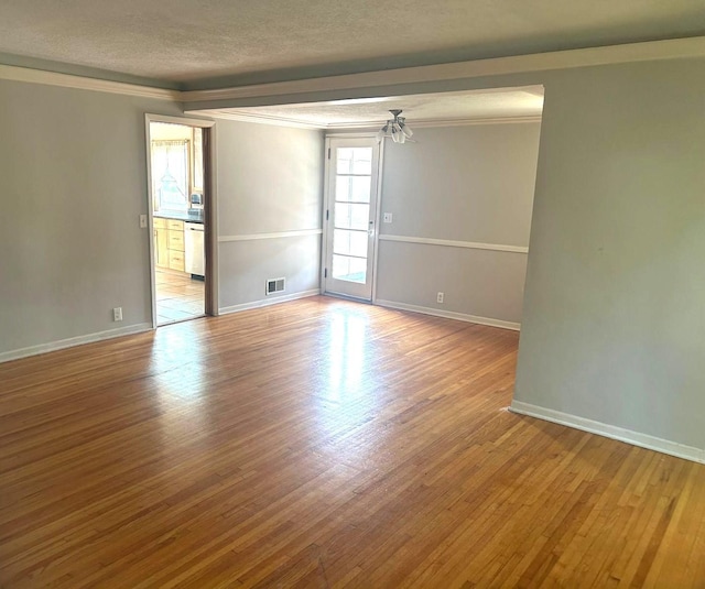 3500 Abbott Ave N, Robbinsdale, MN 55422 - spare room with a textured ceiling, wood finished floors, crown molding, and a ceiling fan