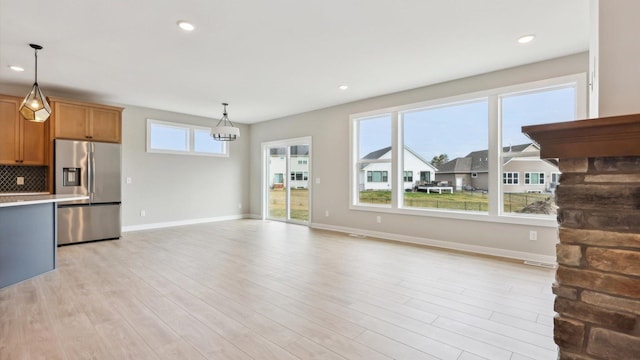 5574 130th Way N, Hugo, MN 55038 - unfurnished living room featuring baseboards, light wood-type flooring, recessed lighting, and a chandelier