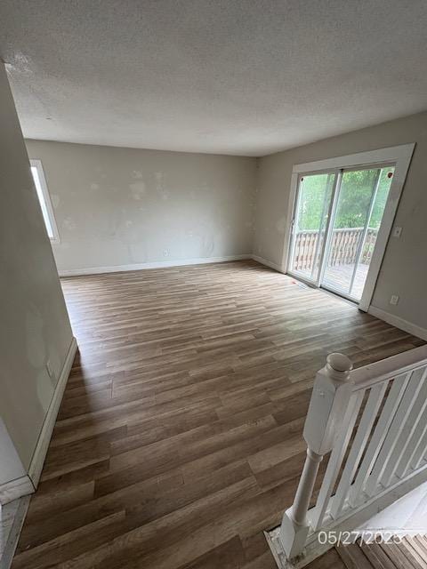 6769 Humboldt Ave N, Brooklyn Center, MN 55430 - empty room with baseboards, wood finished floors, and a textured ceiling