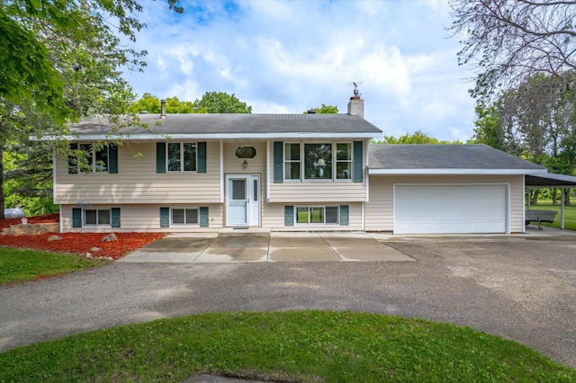 8165 240th St W, Eureka Twp, MN 55044 - raised ranch with driveway, a chimney, and an attached garage