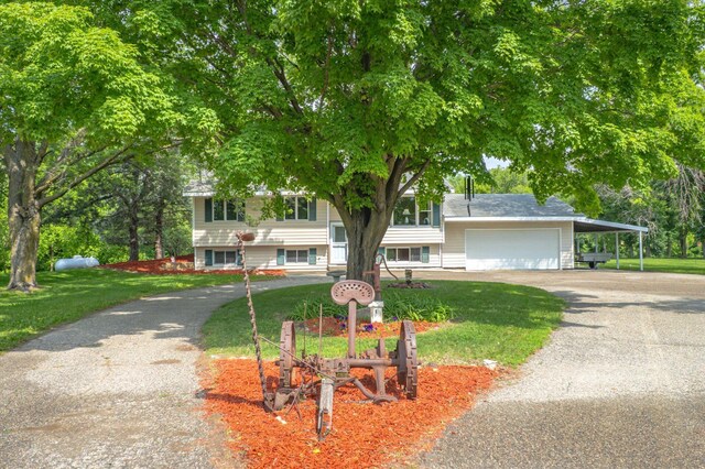 8165 240th St W, Eureka Twp, MN 55044 - view of front of home with asphalt driveway, a carport, a front lawn, and an attached garage