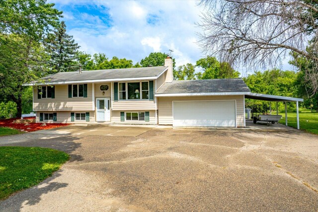 8165 240th St W, Eureka Twp, MN 55044 - raised ranch featuring driveway, a chimney, and an attached garage