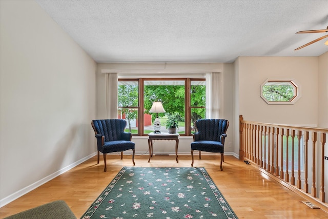 8165 240th St W, Eureka Twp, MN 55044 - living area with a textured ceiling, wood finished floors, ceiling fan, and baseboards