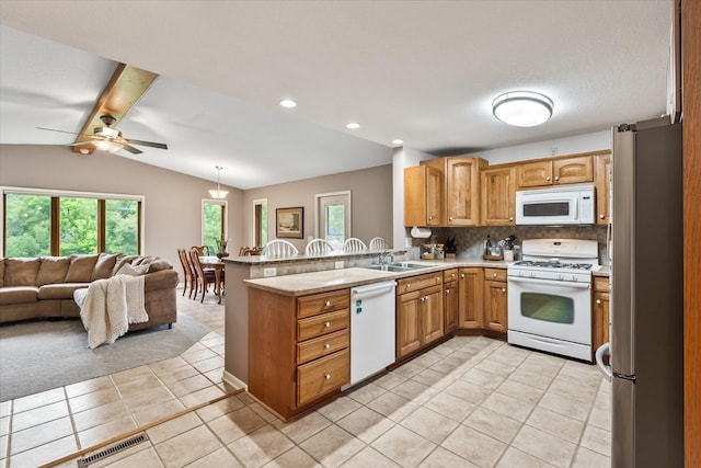 8165 240th St W, Eureka Twp, MN 55044 - kitchen with white appliances, open floor plan, light tile patterned floors, backsplash, and a peninsula
