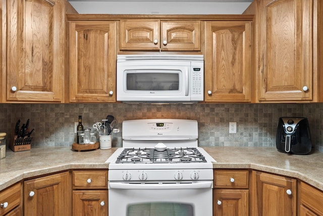 8165 240th St W, Eureka Twp, MN 55044 - kitchen with white appliances, light countertops, brown cabinets, and tasteful backsplash