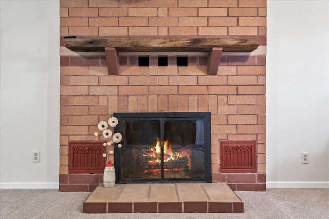8165 240th St W, Eureka Twp, MN 55044 - detailed view of a warm lit fireplace, carpet flooring, and baseboards