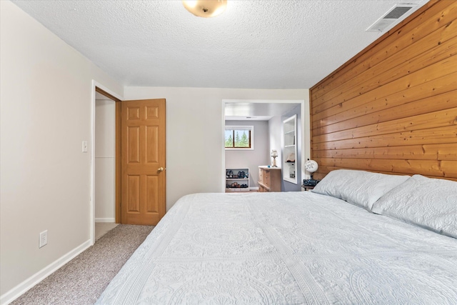 8165 240th St W, Eureka Twp, MN 55044 - carpeted bedroom with a textured ceiling, baseboards, and wood walls
