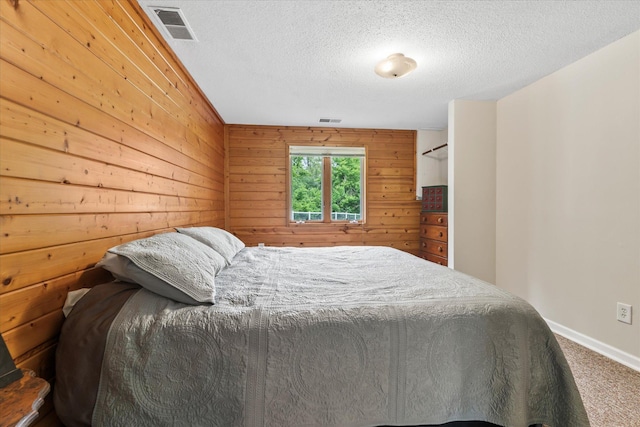 8165 240th St W, Eureka Twp, MN 55044 - carpeted bedroom with a textured ceiling, wooden walls, and baseboards