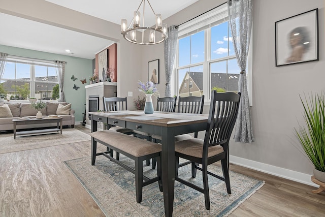 18165 Garland Path, Lakeville, MN 55044 - dining room featuring a chandelier, wood finished floors, and a tile fireplace