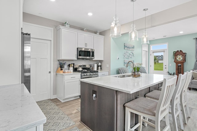 18165 Garland Path, Lakeville, MN 55044 - kitchen featuring stainless steel appliances, light wood-style flooring, white cabinetry, backsplash, and recessed lighting